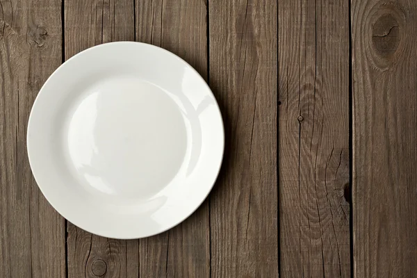 Plate on a wooden surface Stock Image