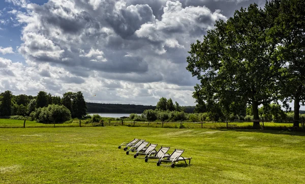 Deckchairs standing on a meadow — Stock Photo, Image