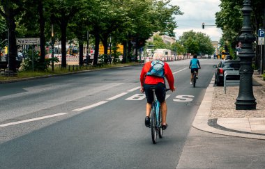 Cyclists in Berlin traffic on the street Unter den Linden