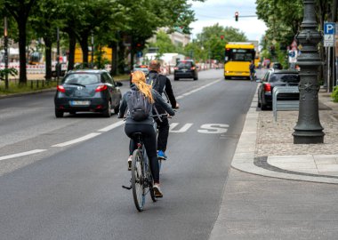 Cyclists in Berlin traffic on the street Unter den Linden