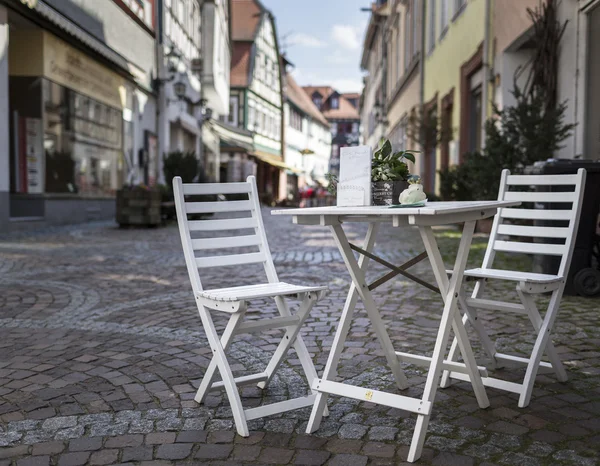 Vita trädgården stolar och bord i en shoppinggata — Stockfoto