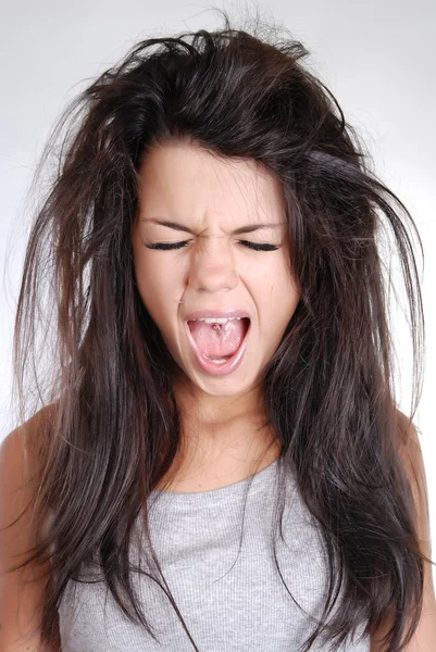 Young girl with messy hair screaming Stock Photo