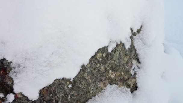 Granite stone surface covered with snow — Stock Video