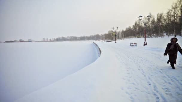 Vista no aterro do lago Onega coberto com neve e mulher — Vídeo de Stock