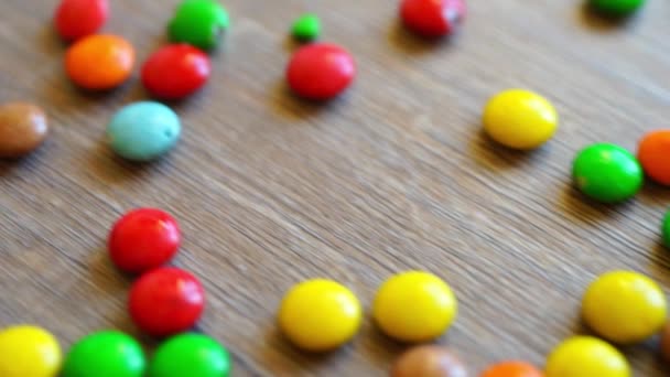 Wooden table with falling candies — Stock Video