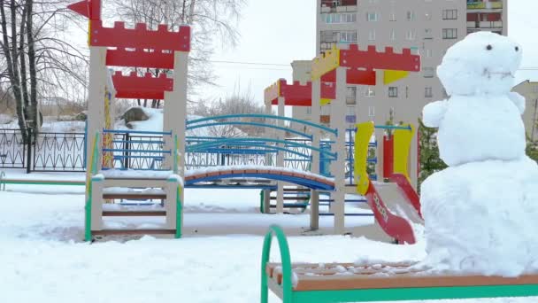 Snögubbe på lekplatsen efter tunga snöfall — Stockvideo