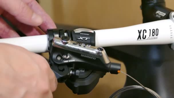 Mechanic Repairing Bicycle, Installing Brake Lever to Handlebar, Closeup Shot in — Stock Video