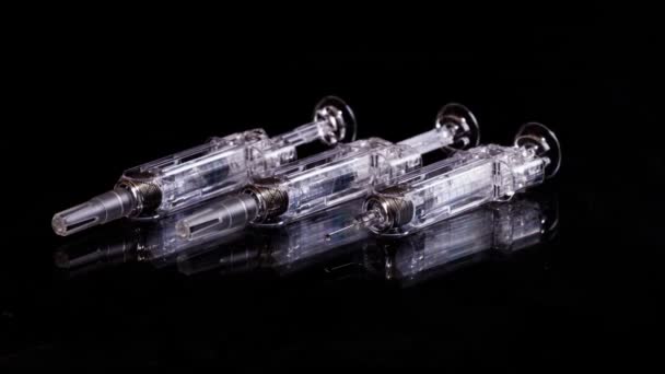 Three Glass Syringes Isolated on Black Background, Slider View — Stok Video