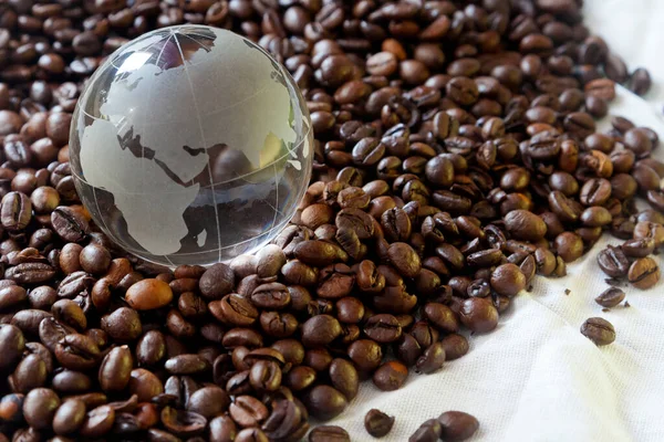 Glass Earth Globe Asia Africa Center Closeup Coffee Beans Background — Stock Photo, Image