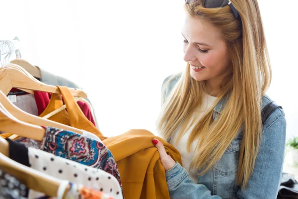 美しい若い女性の衣料品店でのショッピング. — ストック写真