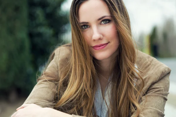 Mooie jonge vrouw kijken camera in de straat. — Stockfoto