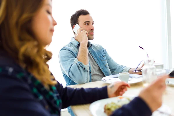 Young couple enjoying breakfast and working at home. — Stock Photo, Image