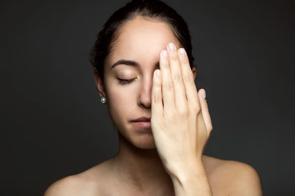 Young woman covering half of her face with a hand. — Stock Photo, Image