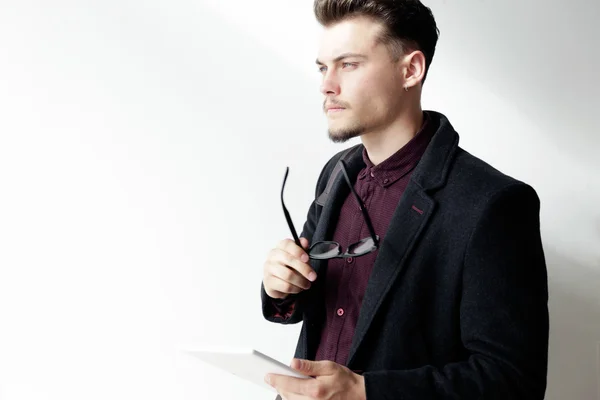 Handsome young man using his digital tablet. Isolated on white. — Stock Photo, Image