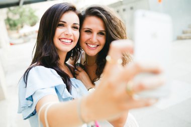 Güzel genç kadın sokakta bir selfie alarak.