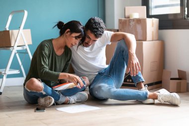 Genç ve çekici bir çiftin dairenin duvarlarını boyarken rengini seçtiği bir resim..