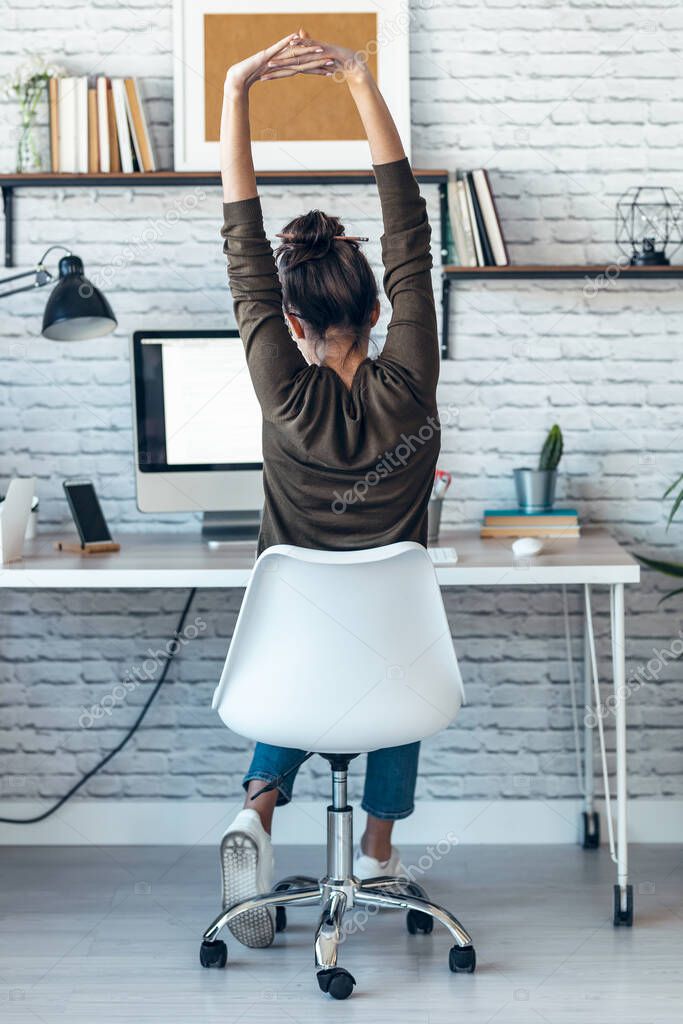 Shot of beautiful businesswoman stretching body for relaxing while working with computer in the office at home.