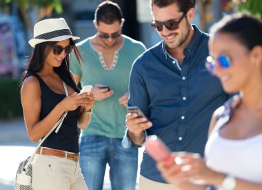 arkadaşlar akıllı telefonlar ile eğlenmek grup portresi.