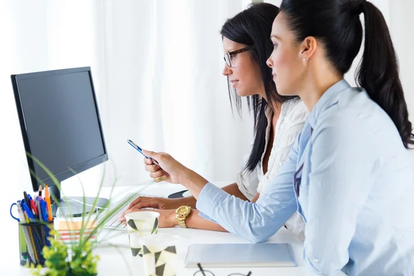 Two business woman working in office with computer. — Stock Photo, Image