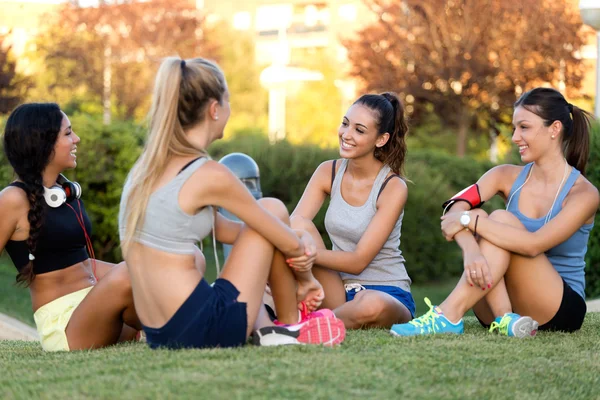 Running girls having fun in the park with mobile phone. — Stock Photo, Image