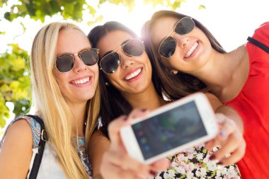 üç arkadaş bir smartphone ile fotoğraf çekmek