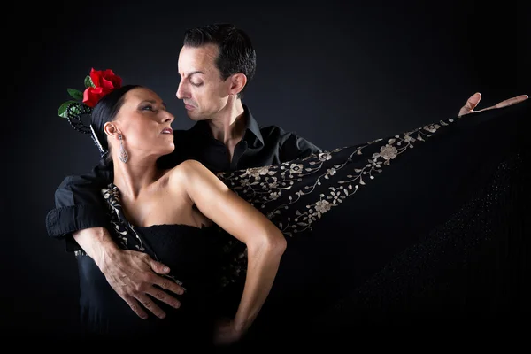 Young flamenco dancers in beautiful dress on black background. — Stock Photo, Image