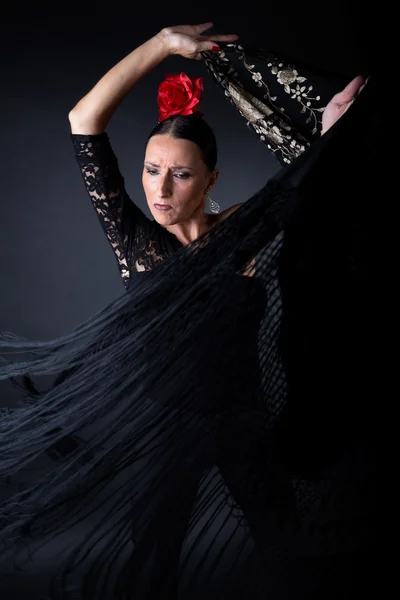 Young flamenco dancer in beautiful dress on black background. — Stock Photo, Image