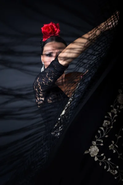 Giovane ballerina di flamenco in bellissimo vestito su sfondo nero . — Foto Stock