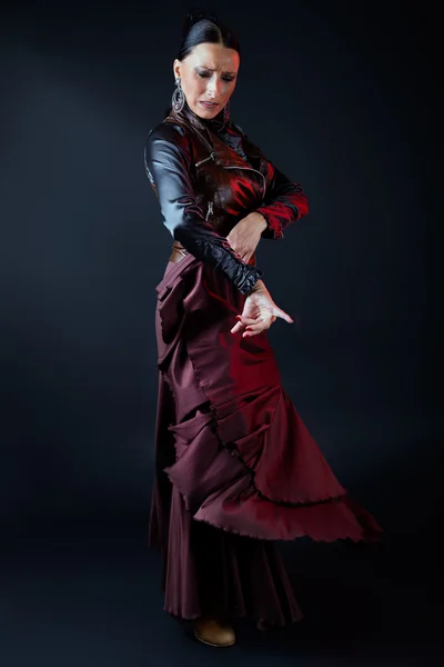 Young flamenco dancer in beautiful dress on black background. — Stock Photo, Image