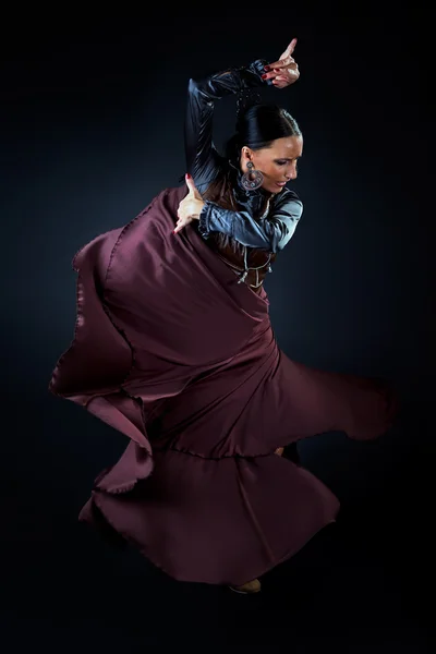 Young flamenco dancer in beautiful dress on black background. — Stock Photo, Image