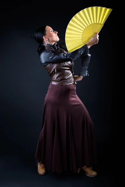 Young flamenco dancer in beautiful dress on black background. — Stock Photo, Image