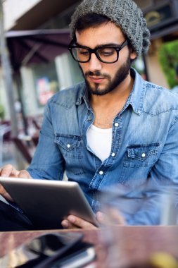 Sokakta dijital tablet ile modern genç adam.