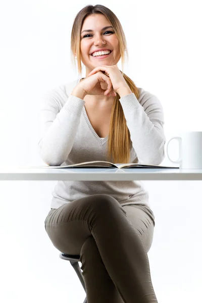 Young beautiful girl reading news and drinking coffee. Isolated — Stock Photo, Image