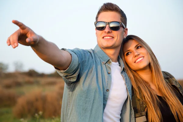 Portrait of happy young couple in field. — Stock Photo, Image