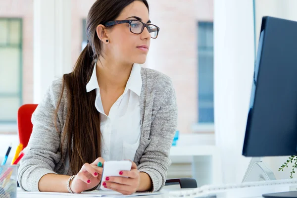 Jeune femme d'affaires travaillant dans son bureau avec ordinateur portable . — Photo