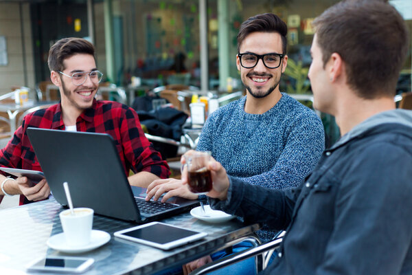 Outdoor portrait of young entrepreneurs working at coffee bar.