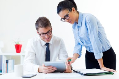 Business people working in the office with digital tablet. clipart