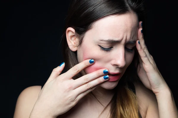 Desperate young woman touching her face. Concept of abuse and de — Stock Photo, Image