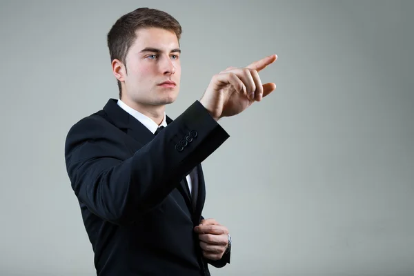 Business man with pointing to something or touching a screen. — Stock Photo, Image