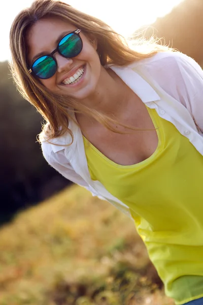 Schöne junge Frau genießt den Sommer auf einem Feld. — Stockfoto