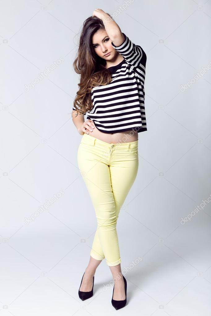 Fashion portrait of pretty young woman posing in the studio photo.