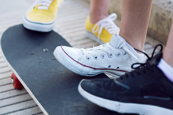 Young women with skateboard in the street. — Stock Photo, Image