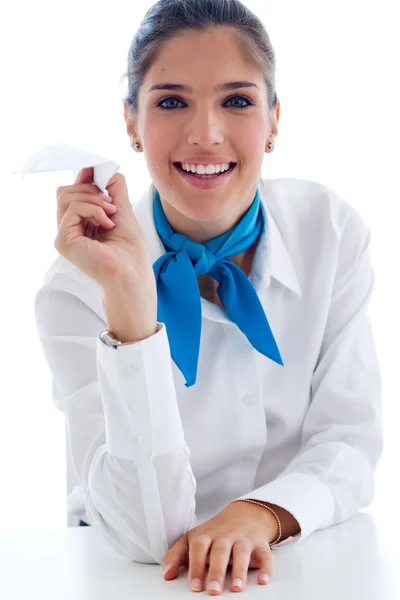 Beautiful hostess holding paper airplane. Isolated on white. — Stock Photo, Image