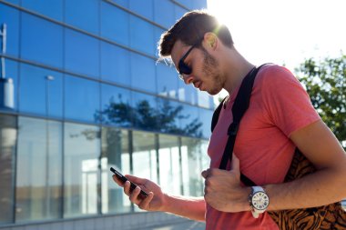 Yakışıklı genç adam sokakta cep telefonunu kullanma.