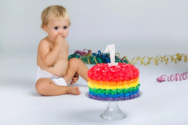 Baby girl celebrating her first birthday with gourmet cake and balloons. — Stock Photo, Image