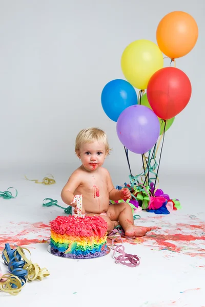 Baby girl celebrating her first birthday with gourmet cake and balloons. — Stock Photo, Image