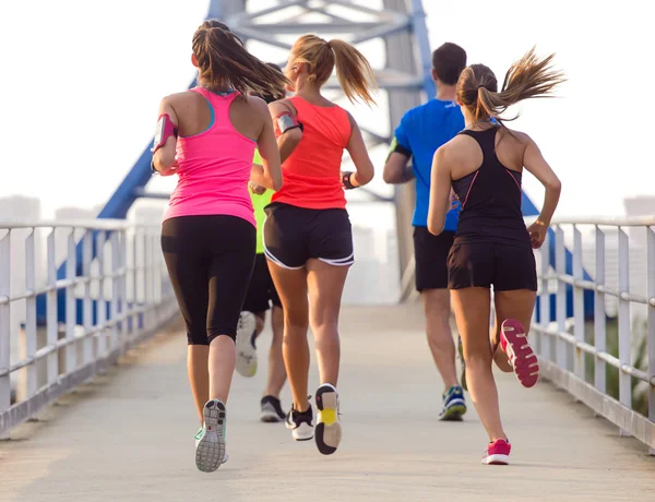 Portrait of group of friends running in the park. — Stock Photo, Image