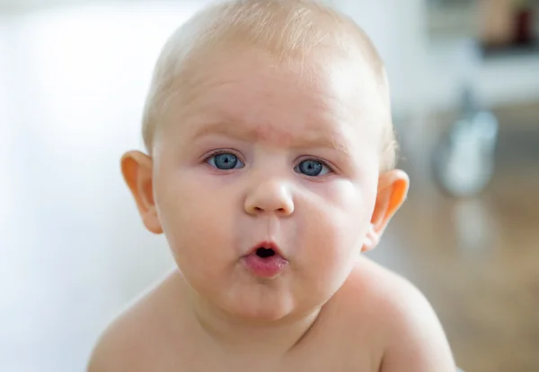 Cute smiling baby sitting at home. — Stock Photo, Image