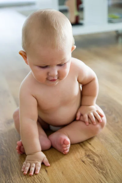 Cute smiling baby sitting at home. — Stock Photo, Image