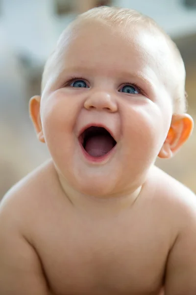 Cute smiling baby sitting at home. — Stock Photo, Image